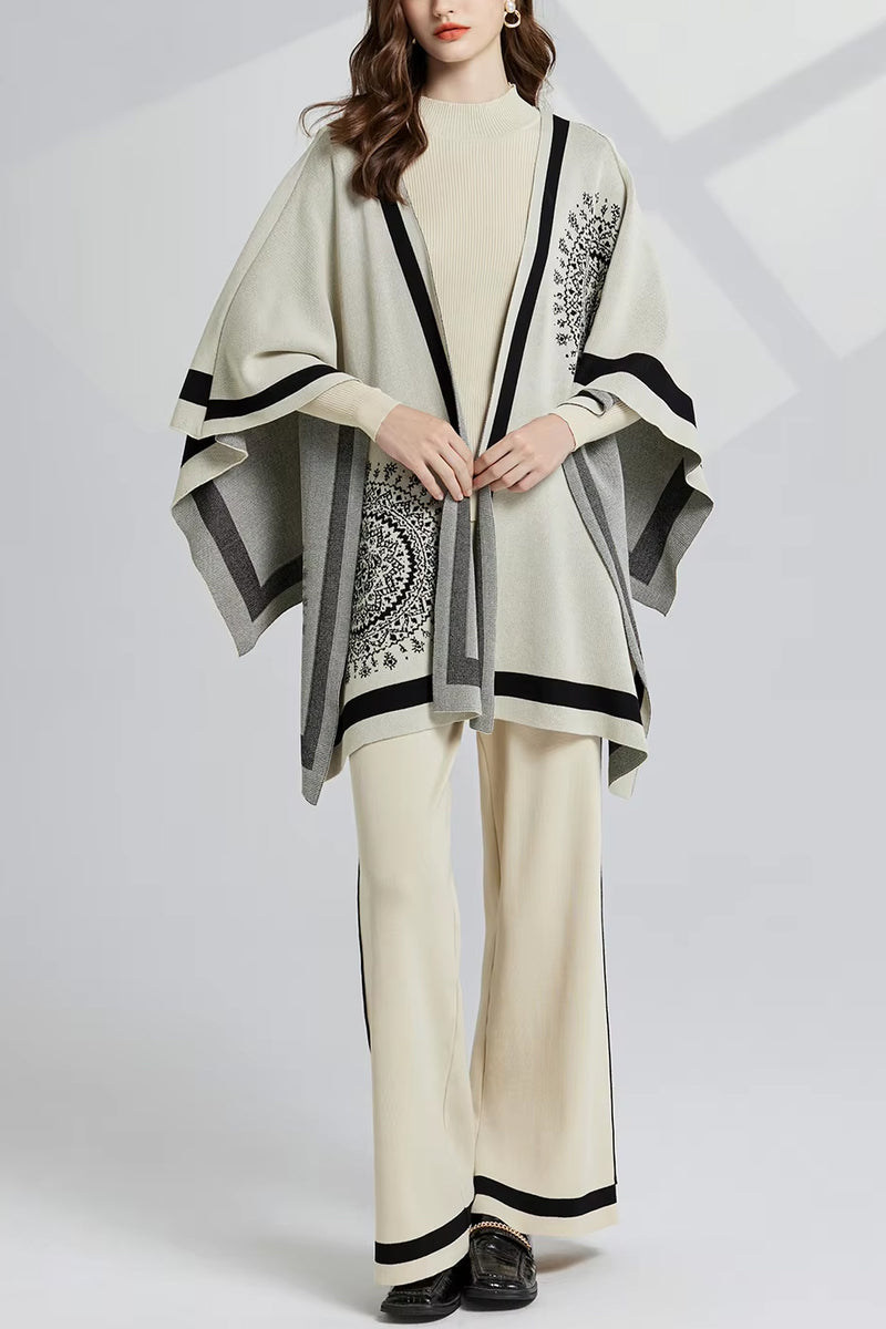 Woman wearing a stylish outfit with a poncho and pants on a white background